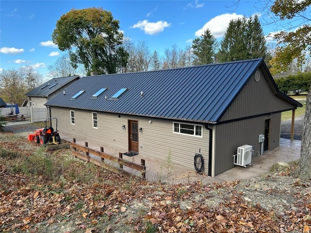 11667 Lakeland Dr, Conneaut Lake, PA 16316 - rear view of property featuring ac unit, a standing seam roof, and metal roof