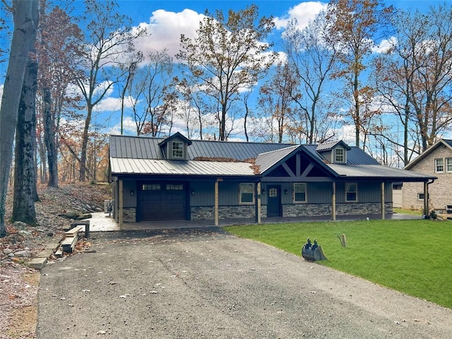 11667 Lakeland Dr, Conneaut Lake, PA 16316 - view of front facade featuring a front yard, stone siding, metal roof, an attached garage, and driveway
