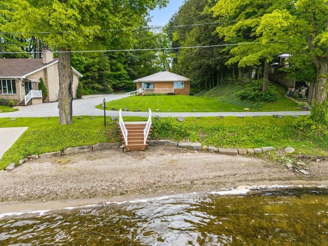 12052 Lake Dr, Conneaut Lake, PA 16316 - view of green lawn with driveway and a view of trees