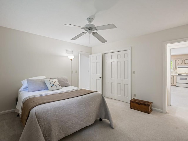12052 Lake Dr, Conneaut Lake, PA 16316 - bedroom with light carpet, a closet, baseboards, and ceiling fan