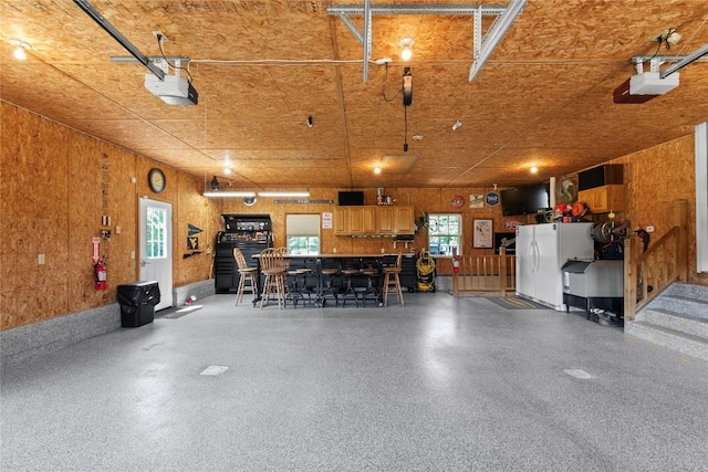 18376 Barber Rd, Meadville, PA 16335 - garage featuring freestanding refrigerator and a garage door opener