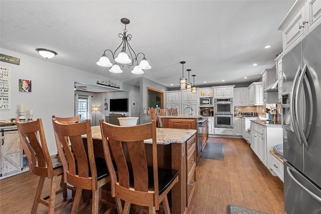 18376 Barber Rd, Meadville, PA 16335 - kitchen with stainless steel appliances, a center island with sink, a chandelier, dark wood-style floors, and recessed lighting