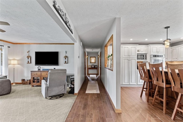 18376 Barber Rd, Meadville, PA 16335 - living area with a textured ceiling, wood finished floors, recessed lighting, a ceiling fan, and ornamental molding