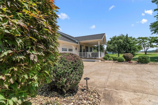 18376 Barber Rd, Meadville, PA 16335 - rear view of property featuring an attached garage, concrete driveway, and a porch