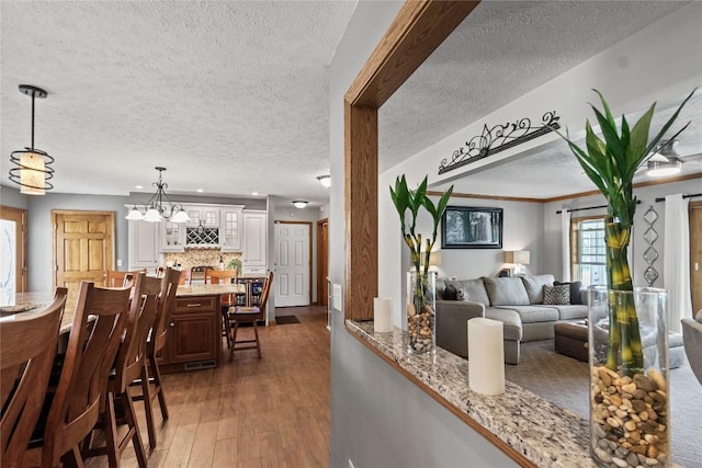 18376 Barber Rd, Meadville, PA 16335 - dining space featuring a textured ceiling, dark wood finished floors, and a chandelier
