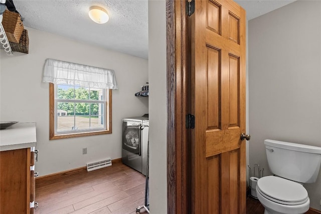 18376 Barber Rd, Meadville, PA 16335 - washroom featuring independent washer and dryer, wood finished floors, and a textured ceiling