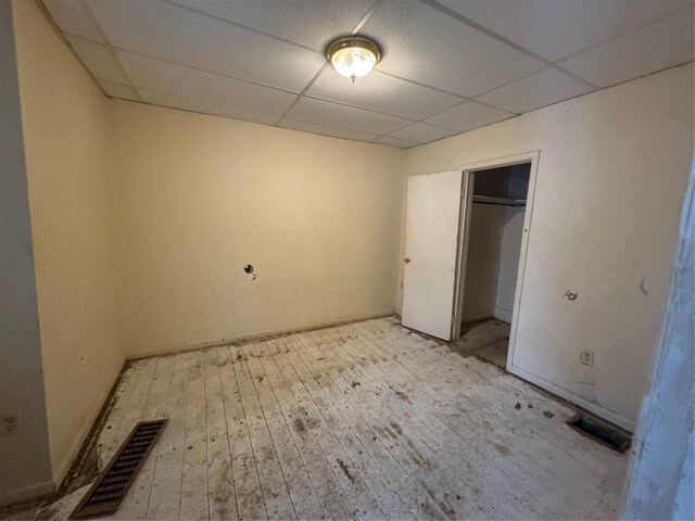 647-649 E 11th St, Erie, PA 16503 - unfurnished bedroom with a drop ceiling, light wood-style floors, a closet, and baseboards