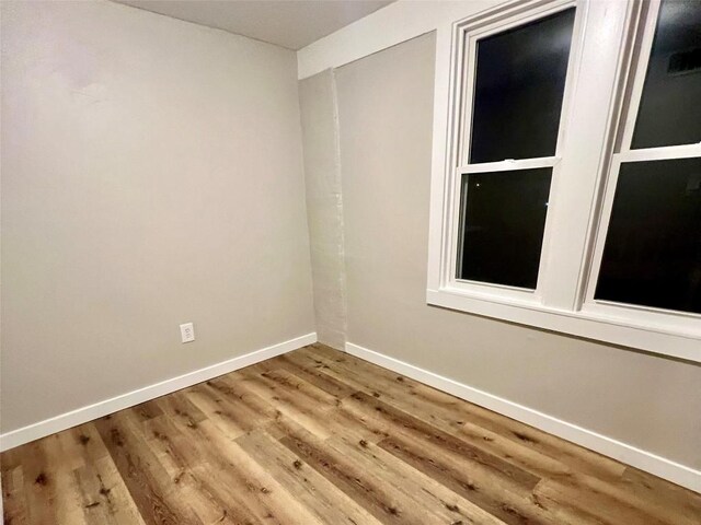 647-649 E 11th St, Erie, PA 16503 - empty room with wood finished floors and baseboards