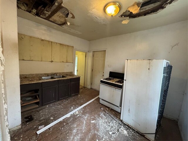 647-649 E 11th St, Erie, PA 16503 - kitchen with white appliances, a sink, and dark cabinetry
