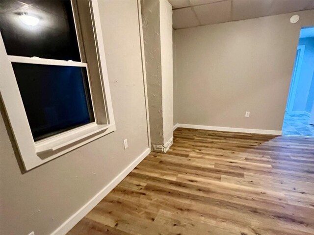 647-649 E 11th St, Erie, PA 16503 - unfurnished bedroom featuring a drop ceiling, baseboards, and wood finished floors