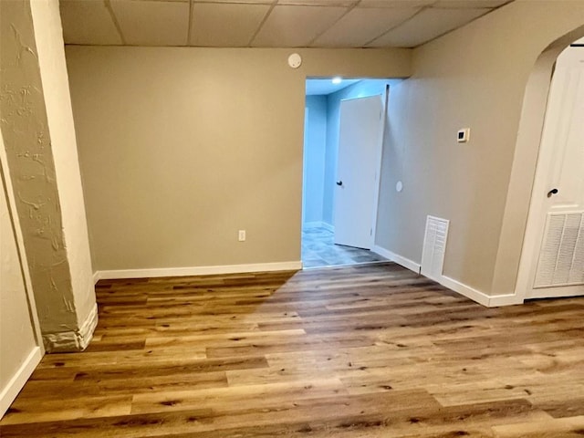 647-649 E 11th St, Erie, PA 16503 - empty room with a paneled ceiling, wood finished floors, arched walkways, and baseboards