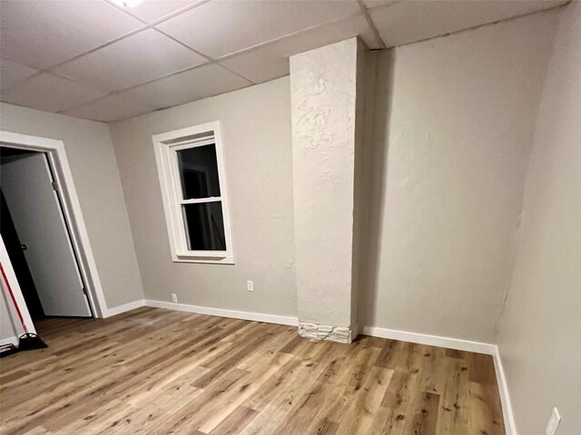 647-649 E 11th St, Erie, PA 16503 - empty room with a paneled ceiling, light wood-style flooring, and baseboards