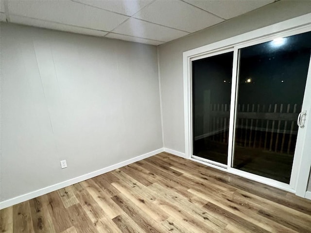 647-649 E 11th St, Erie, PA 16503 - empty room featuring wood finished floors, baseboards, and a paneled ceiling