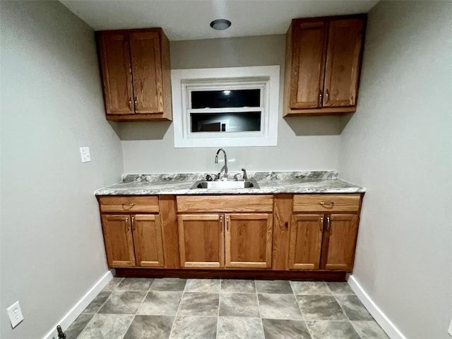 647-649 E 11th St, Erie, PA 16503 - kitchen with a sink, baseboards, brown cabinetry, and light countertops