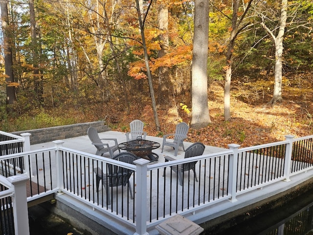 wooden terrace with a fire pit