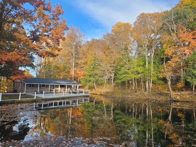 rear view of property with a water view