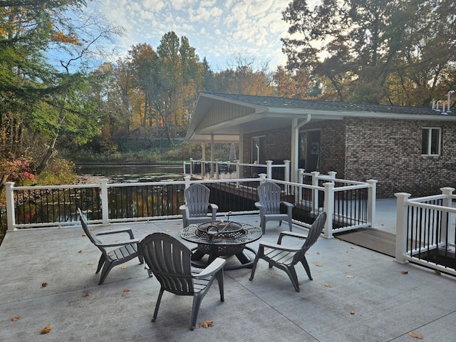 view of patio / terrace with a deck and an outdoor fire pit