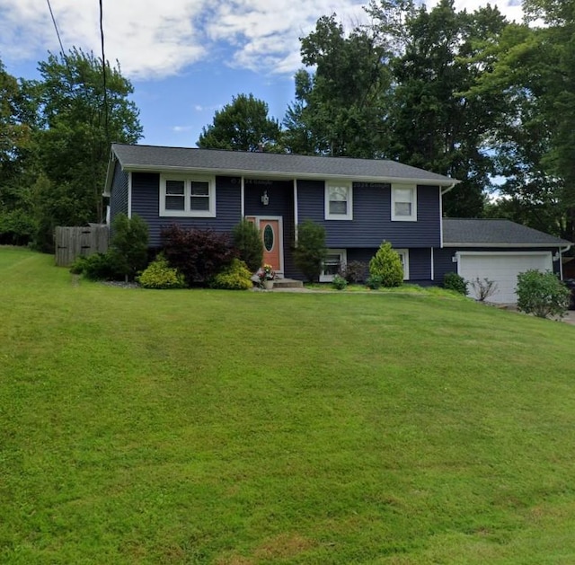 view of front of house featuring a garage and a front yard