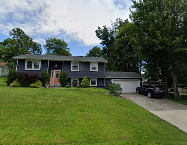 view of front of house featuring a garage and a front lawn