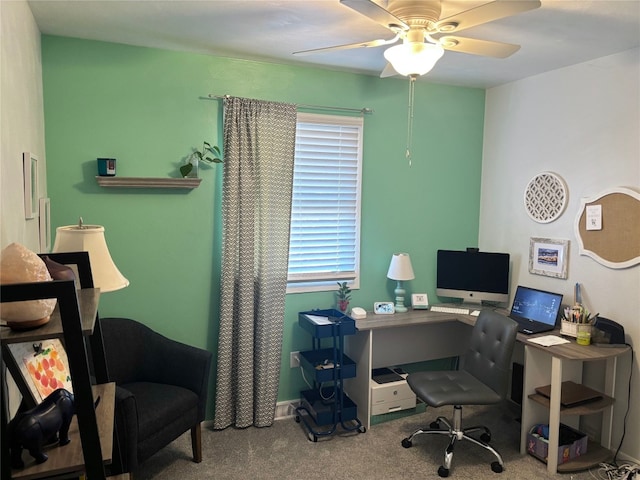 carpeted home office featuring ceiling fan