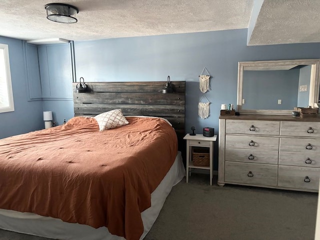 carpeted bedroom featuring a textured ceiling