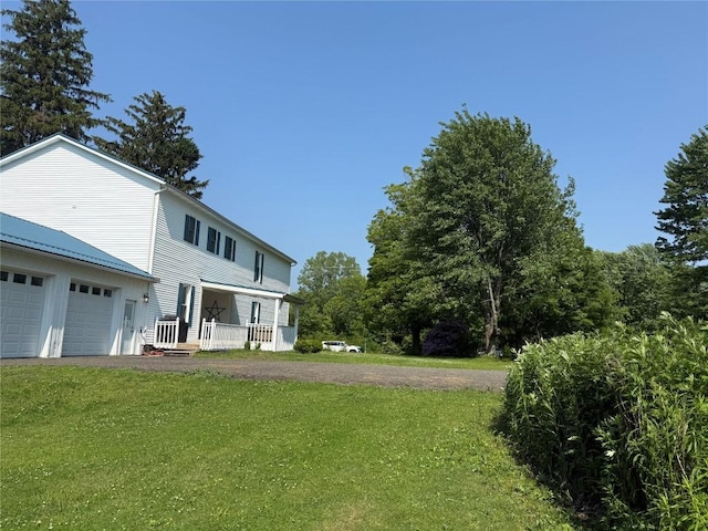 5700 Franklin Rd, Fairview, PA 16415 - view of green lawn featuring dirt driveway, covered porch, and an attached garage