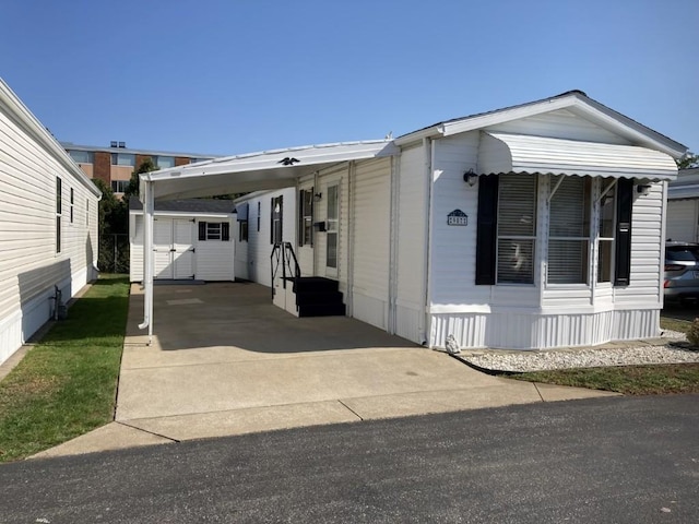 view of front of house with a shed and a carport