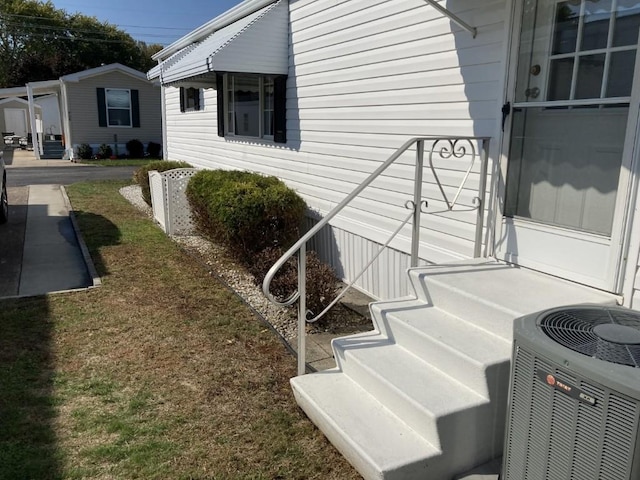 view of side of property with central air condition unit