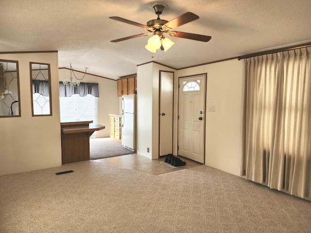 interior space featuring crown molding, lofted ceiling, and a textured ceiling