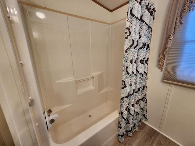 bathroom featuring shower / tub combo with curtain, ornamental molding, and hardwood / wood-style floors