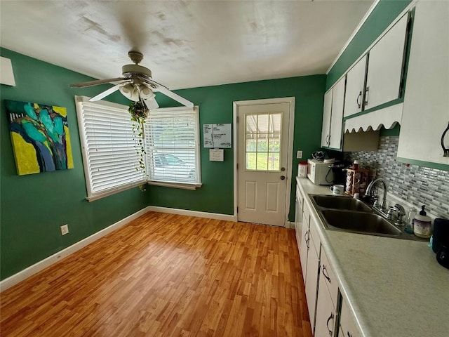 3508 Emerson Ave, Erie, PA 16508 - kitchen featuring ceiling fan, backsplash, light wood-type flooring, and white cabinetry