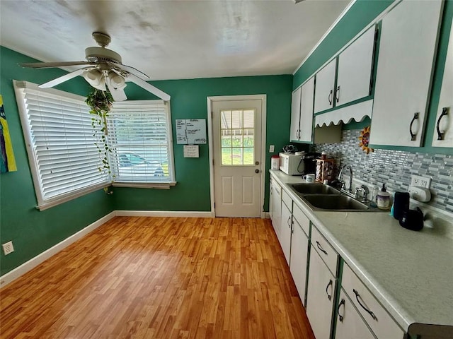 3508 Emerson Ave, Erie, PA 16508 - kitchen with backsplash, light countertops, a ceiling fan, light wood-style floors, and white microwave