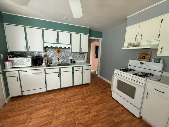 3508 Emerson Ave, Erie, PA 16508 - kitchen with white appliances, under cabinet range hood, arched walkways, tasteful backsplash, and light countertops