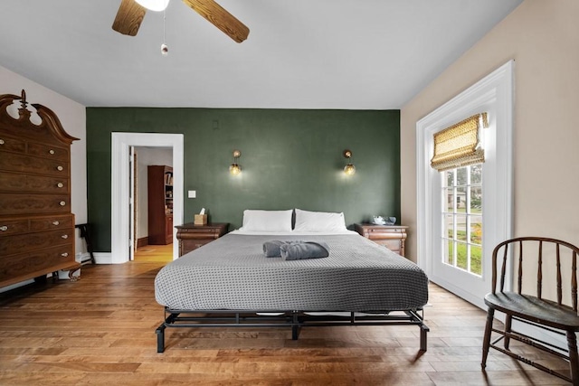 51-55 E Main St, North East, PA 16428 - bedroom with light wood-style flooring, an accent wall, ceiling fan, and baseboards