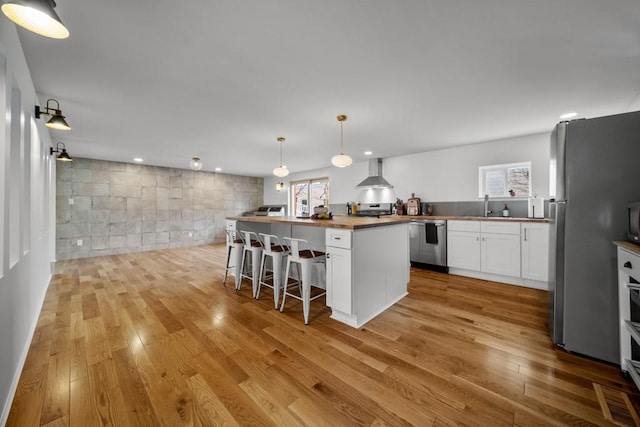 51-55 E Main St, North East, PA 16428 - kitchen with wall chimney range hood, butcher block counters, appliances with stainless steel finishes, plenty of natural light, and recessed lighting
