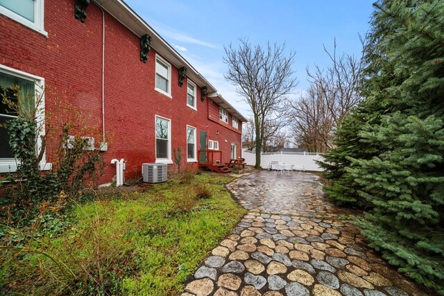 51-55 E Main St, North East, PA 16428 - view of property exterior featuring brick siding and central air condition unit