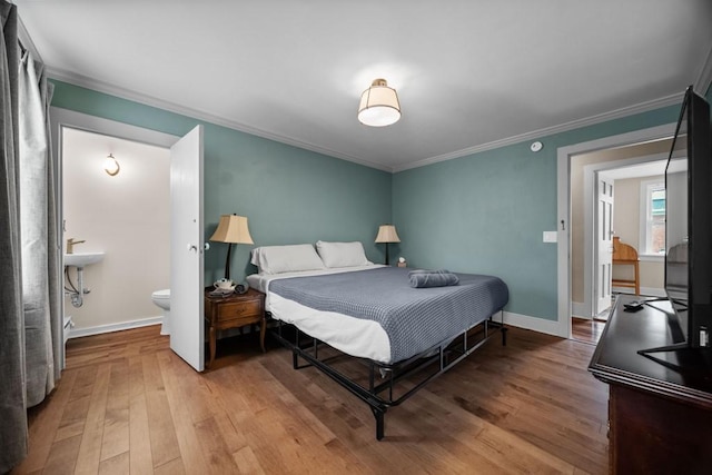 51-55 E Main St, North East, PA 16428 - bedroom with wood finished floors, crown molding, baseboards, and ensuite bathroom