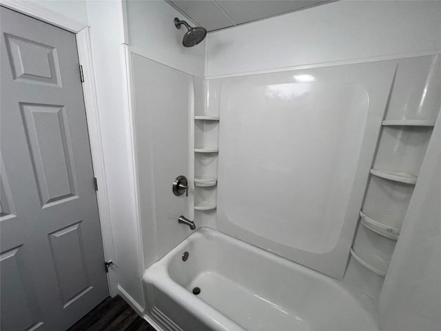 bathroom with shower / washtub combination and hardwood / wood-style flooring