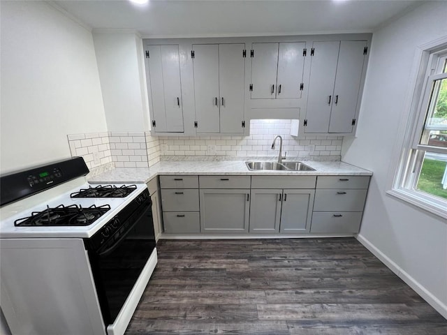 kitchen with sink, gray cabinetry, range with gas cooktop, and dark hardwood / wood-style flooring