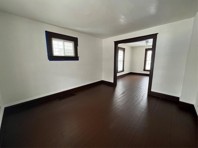 empty room featuring dark hardwood / wood-style flooring