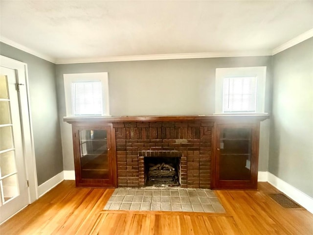 115 W 32nd St, Erie, PA 16508 - unfurnished living room with wood finished floors, a brick fireplace, and ornamental molding