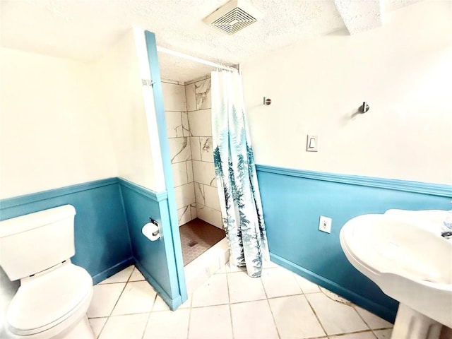 115 W 32nd St, Erie, PA 16508 - bathroom with a stall shower, tile patterned flooring, and a textured ceiling