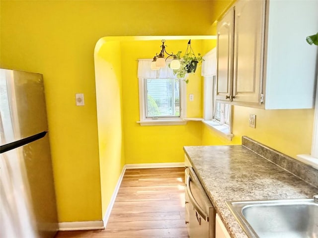 115 W 32nd St, Erie, PA 16508 - kitchen featuring appliances with stainless steel finishes, light wood-type flooring, and light countertops