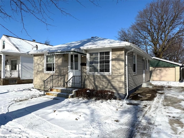 view of front of house featuring a garage and an outdoor structure