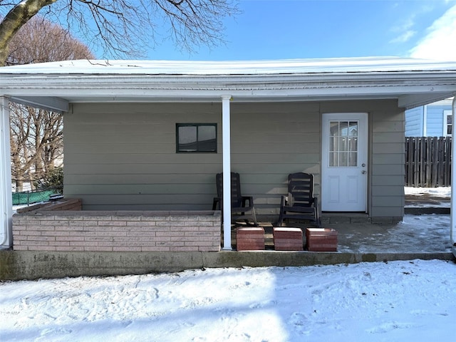 view of snow covered property entrance