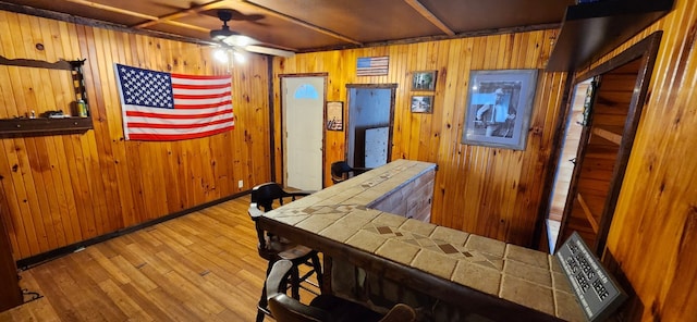 interior space featuring light hardwood / wood-style flooring and wood walls