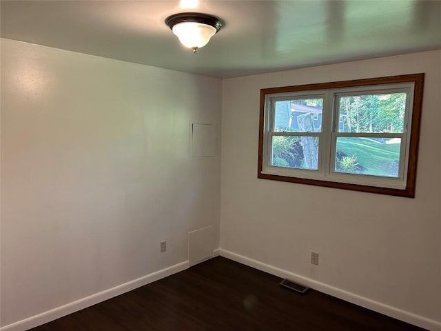 unfurnished room with dark hardwood / wood-style flooring