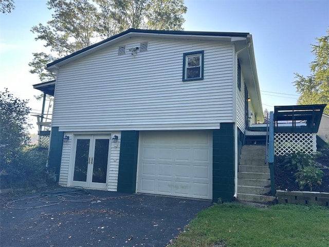 view of home's exterior featuring french doors and a garage