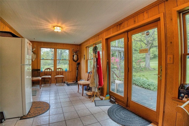 23186 Hatchtown Rd, Spartansburg, PA 16434 - doorway to outside featuring light tile patterned flooring and wood walls