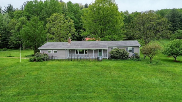 23186 Hatchtown Rd, Spartansburg, PA 16434 - single story home featuring a front lawn, covered porch, a chimney, and a view of trees
